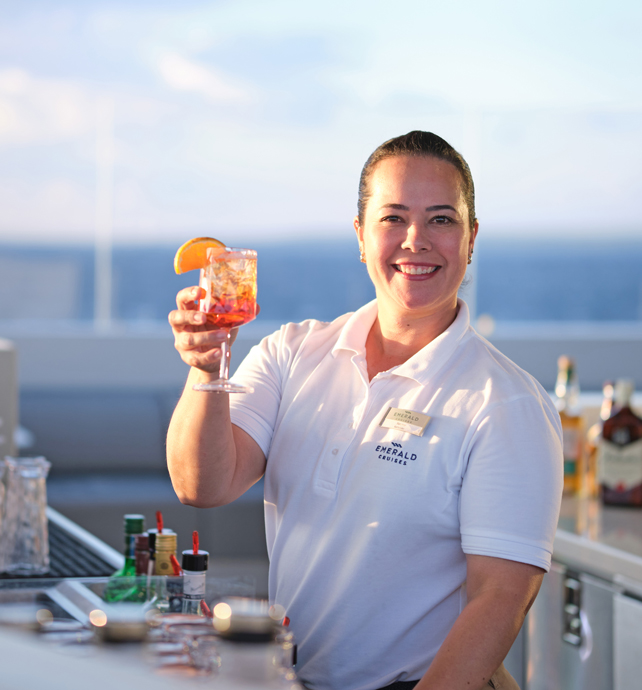 Bar staff holding drink on board Emerald Sakara superyacht