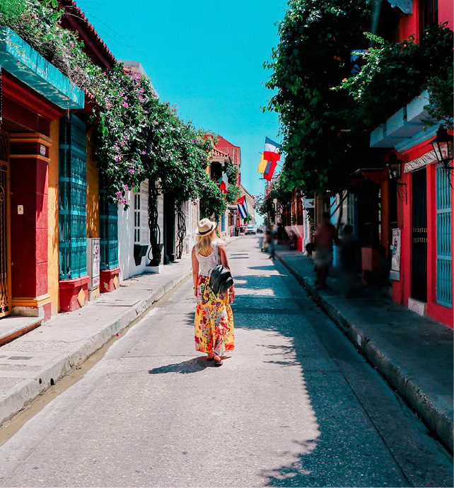 Lady exploring a colourful street in Cartagena, Columbia