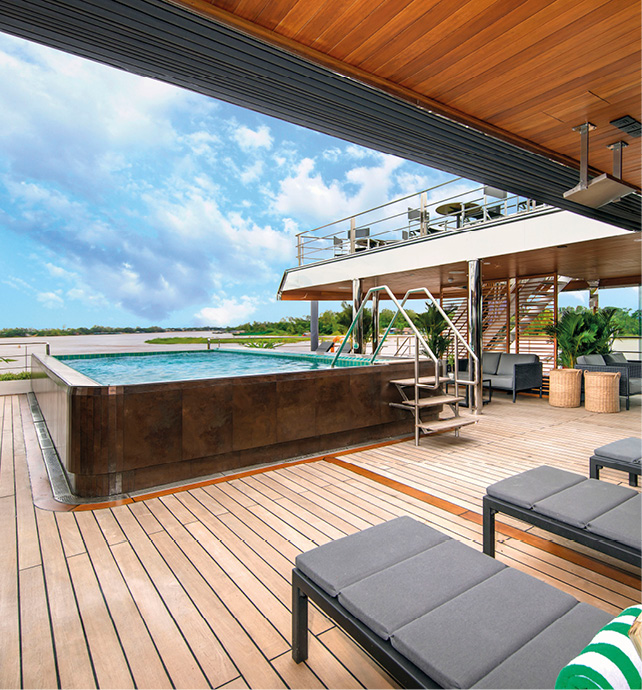 Emerald Harmony’s pool area, with freshly scrubbed decking and sun loungers and blue cloudy sky 