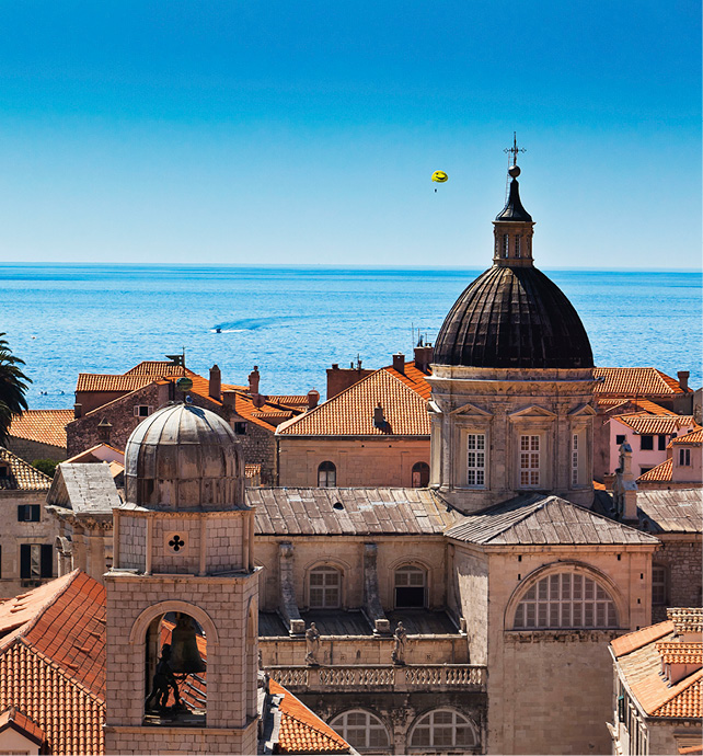 The red-roofed buildings of Dubrovnik, with the Adriatic Sea in the distance